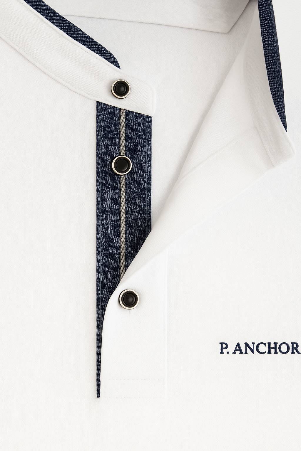 "Close-up of button placket on white P.Anchor polo shirt, showing navy inner lining, contrast stitching, and snap buttons"