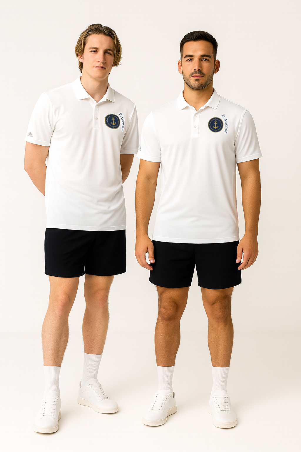 "Two male models wearing white Adidas x P.Anchor polo shirts with navy anchor logo, black shorts, and white sneakers in a clean white studio – premium campaign shot."