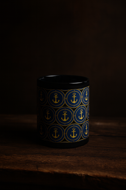 Black mug with blue anchor pattern on a dark background