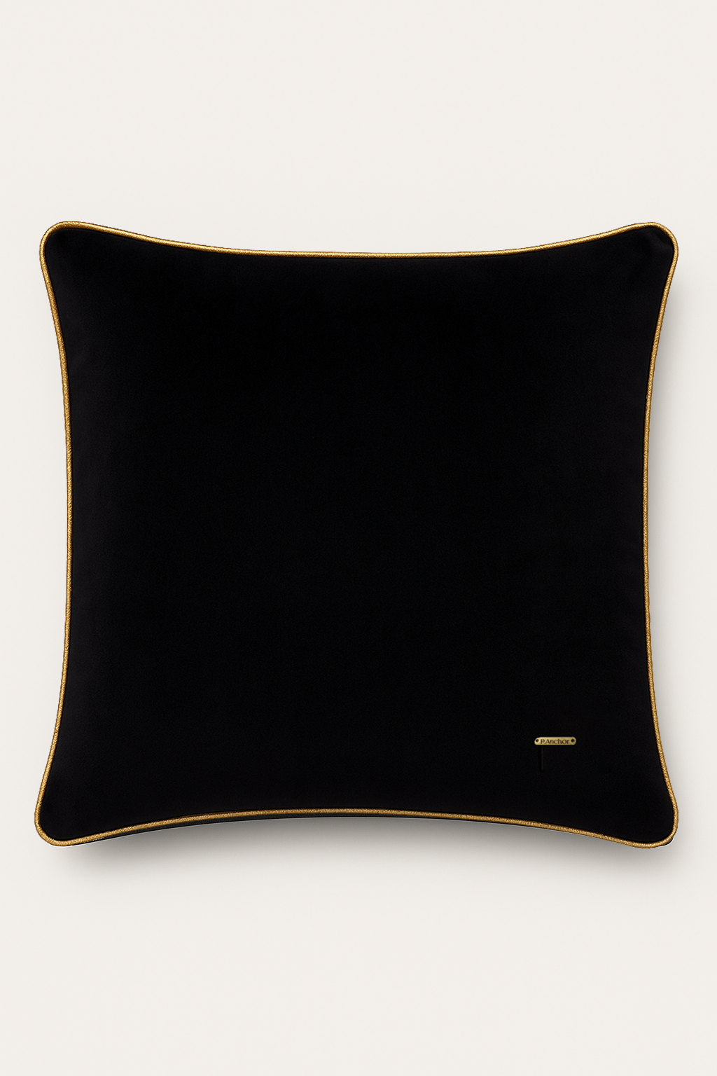 Black pillow with gold trim on a white background