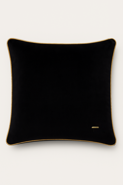 Black pillow with gold trim on a white background