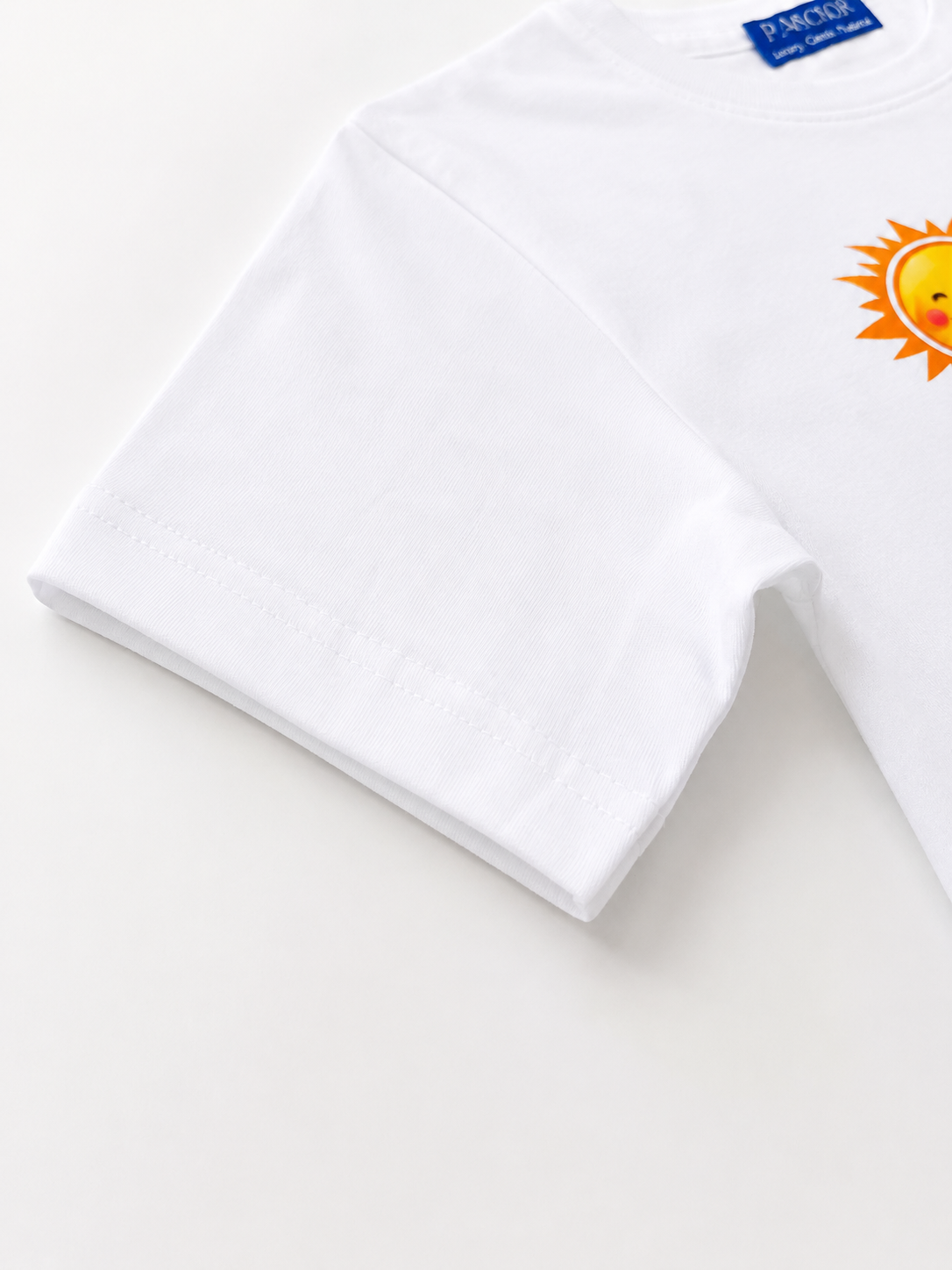 White towel with a sun logo on a light gray background