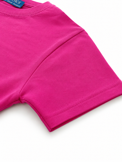Close-up of bright pink shorts with a brand label on a white background