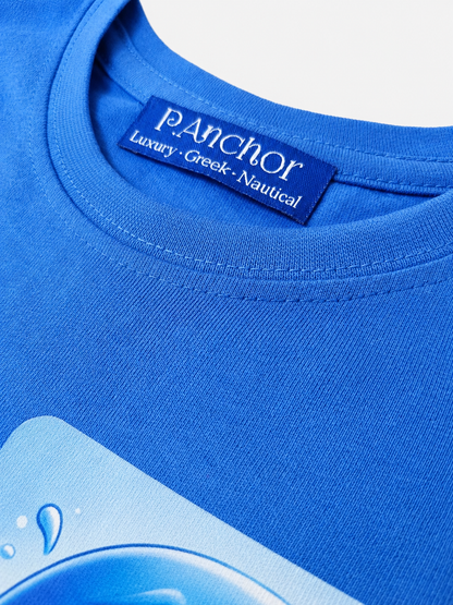 Close-up of a blue t-shirt with a brand label on a light gray background