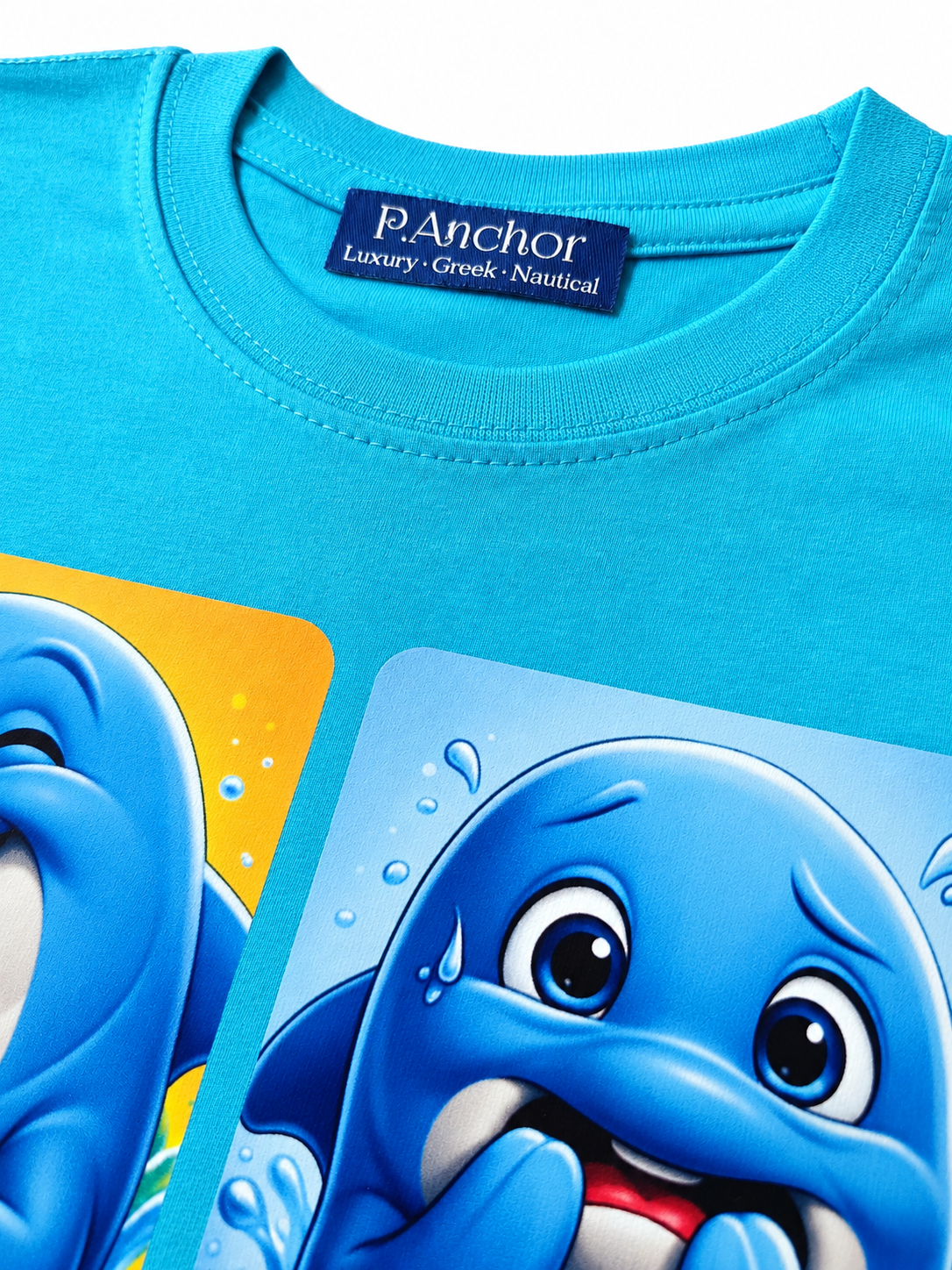 Blue t-shirt with cartoon dolphins and P. Anchor brand label