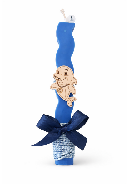 Blue candle with a cartoon character on top, tied with a blue ribbon against a white background