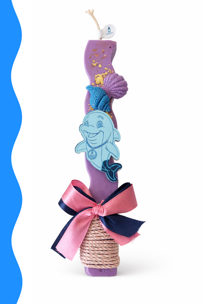 Decorative item with a dolphin design, pink ribbon, and purple base on a white background.