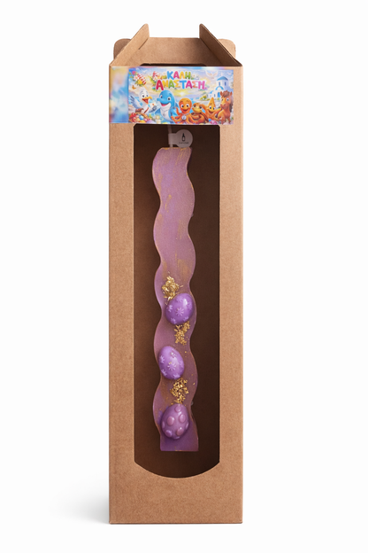 Purple wavy candle with decorative elements in a cardboard box packaging.