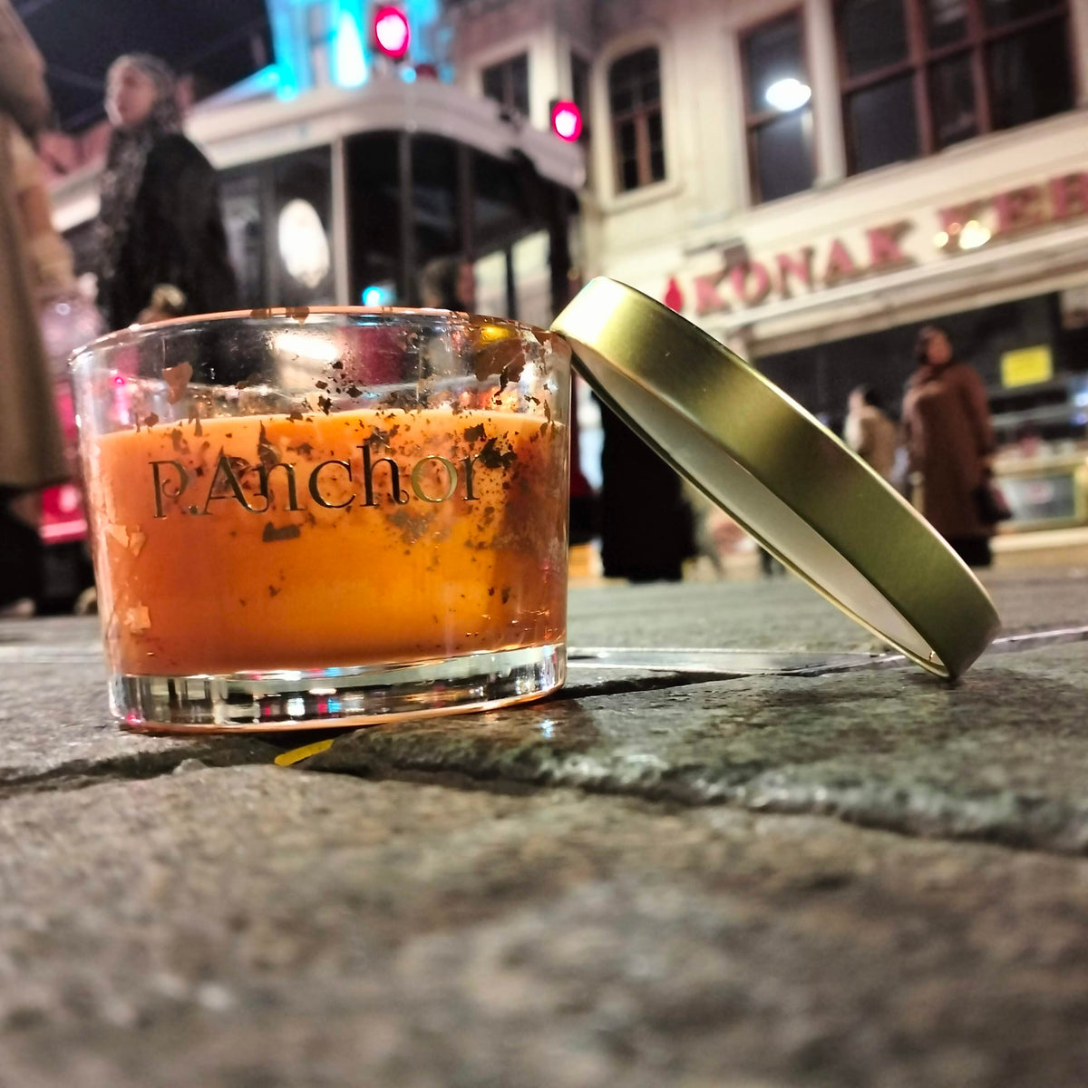 A clear glass candle jar with the brand name 'P.A.