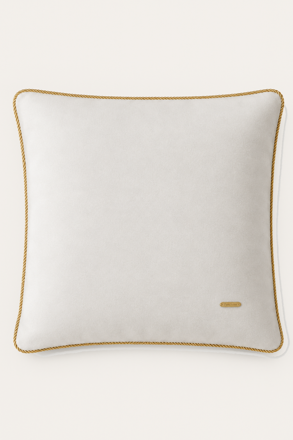 Ivory pillow with gold trim on a white background