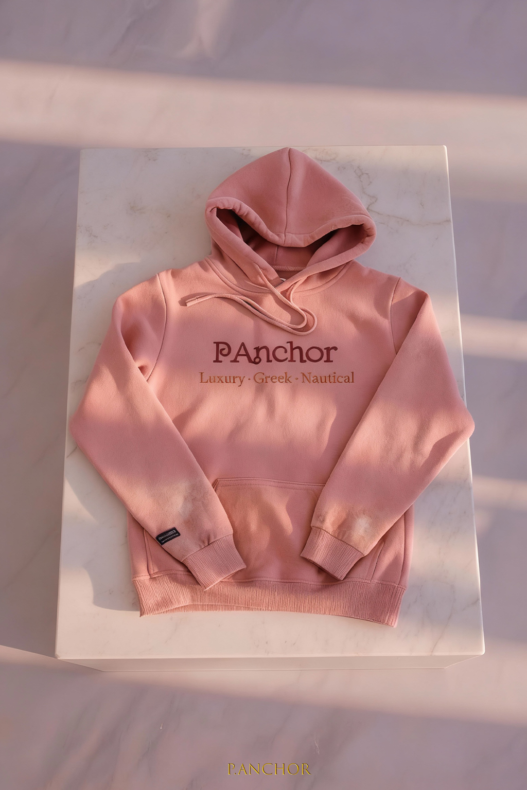 Pink hoodie with 'Panchor' branding on a white background