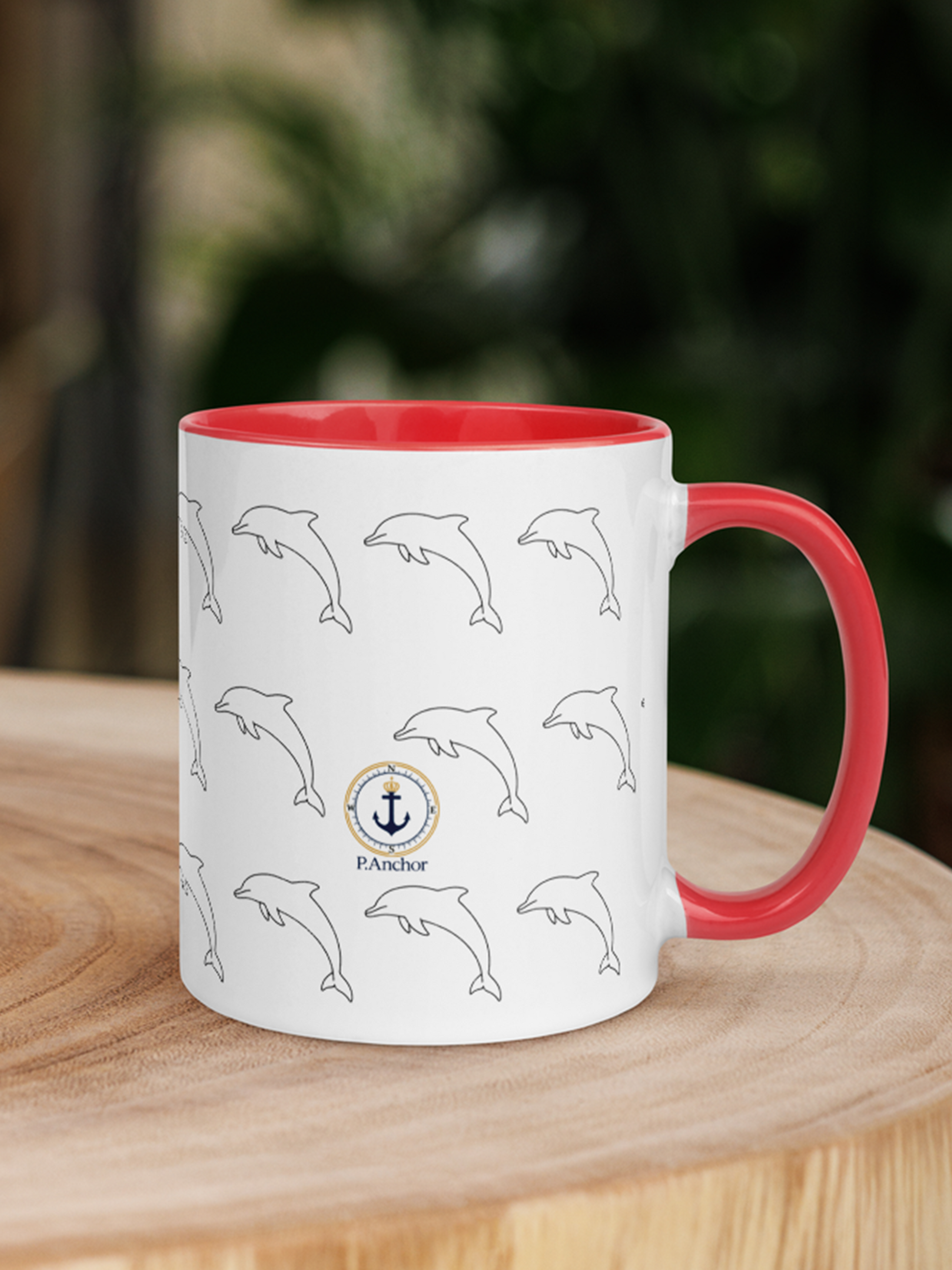 White ceramic mug with red interior and handle, dolphin pattern and P.ANCHOR nautical logo