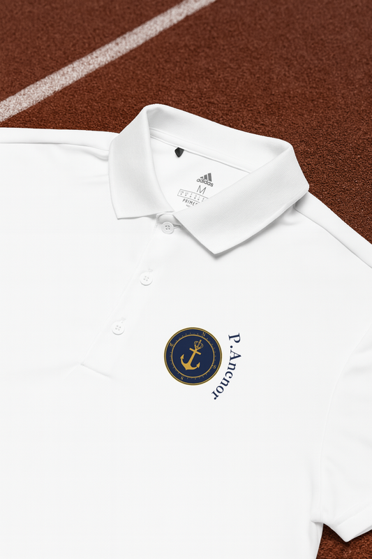 “White Adidas polo shirt with P. Anchor navy and gold anchor logo, displayed on a running track.”