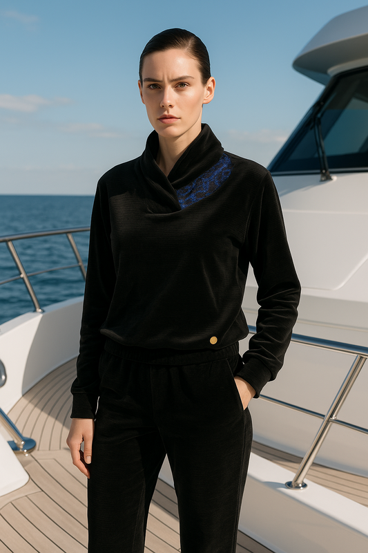 "Luxury women's black velvet tracksuit with blue detail and draped collar – nautical style loungewear by P. ANCHOR, photographed on yacht"