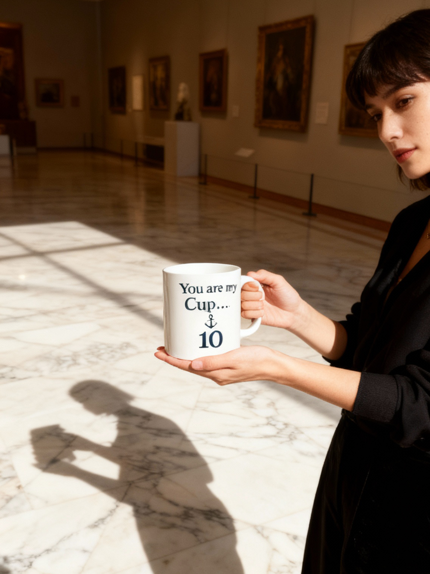 Woman holding a mug with text in an art gallery