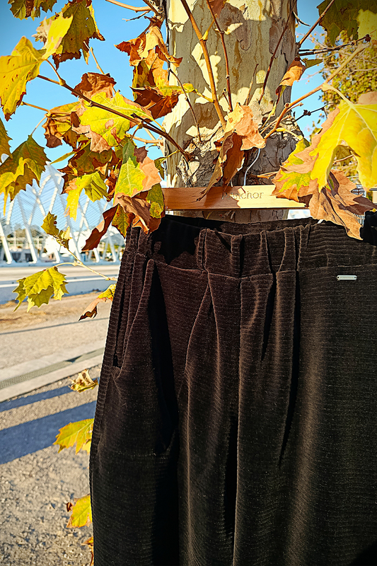 BLACK pants on a mannequin with autumn leaves in the background