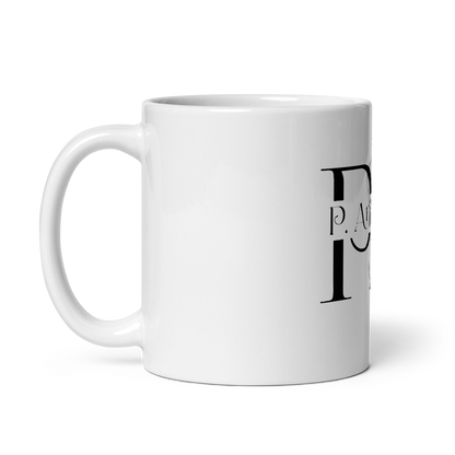 White ceramic mug P.ANCHOR with calligraphic logo and subtle nautical anchor and crown design.